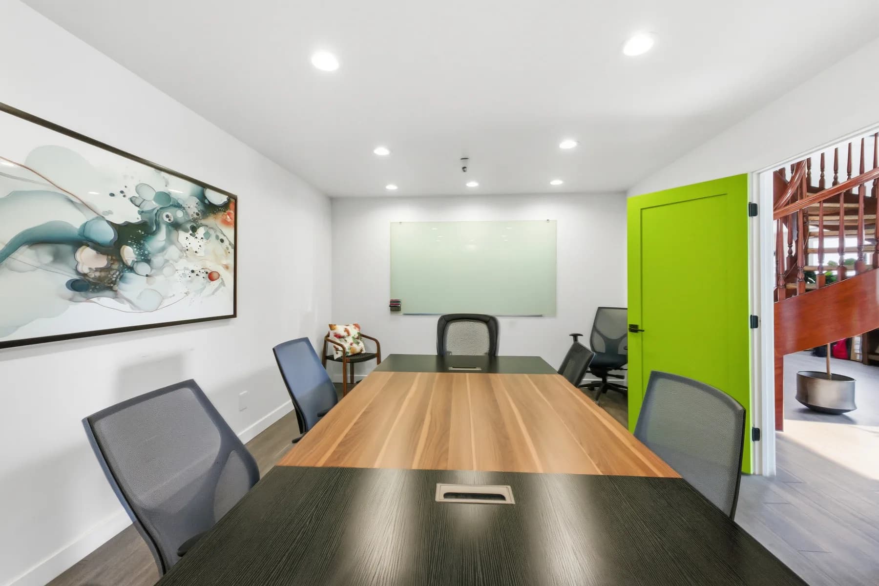 Conference room with a glass writing board and green door