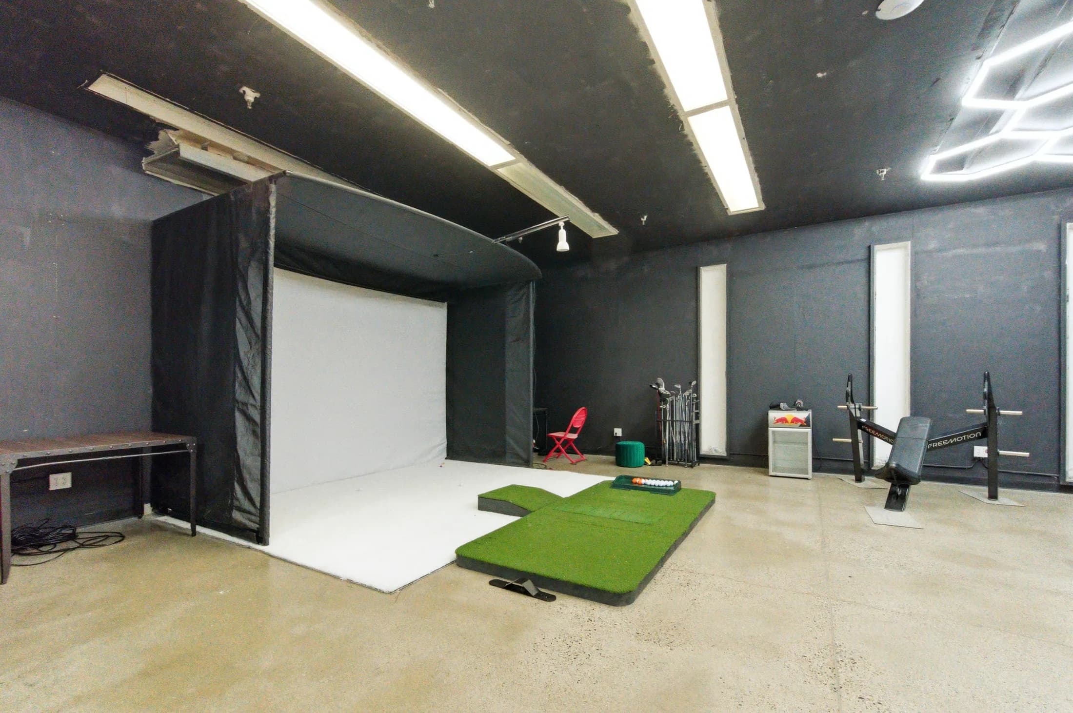 Golf simulator room inside The Anata Building