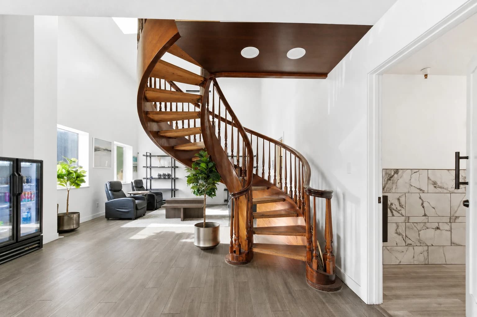 Curved wooden staircase connecting the shared spaces at The Anata Building